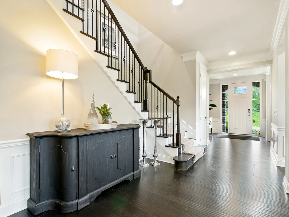 hallway-painting-grand-entrance-hall-york-painters Grand entrance hall with a staircase, dark sideboard and lamp