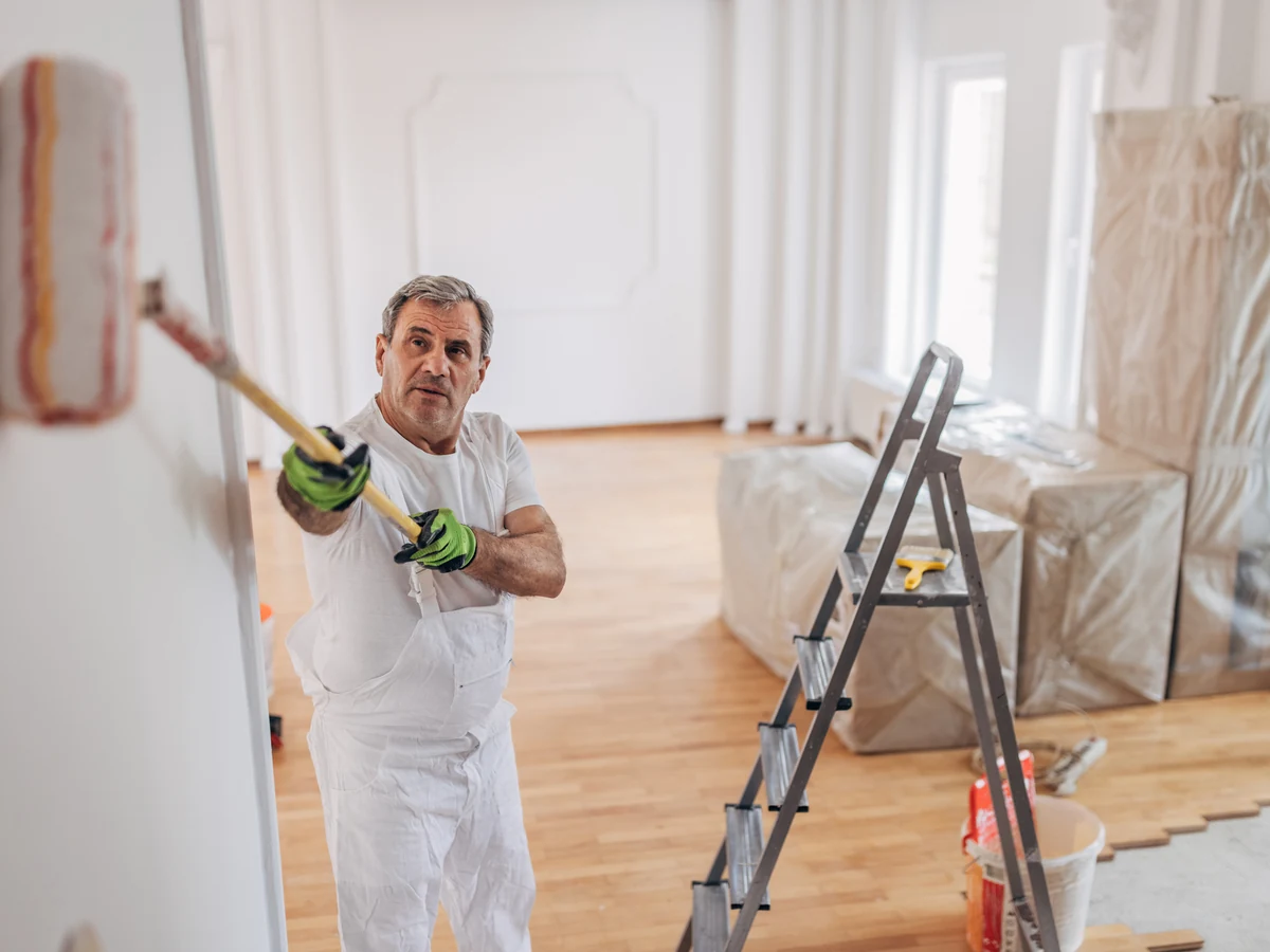 Professional painter assessing interior doors in York property