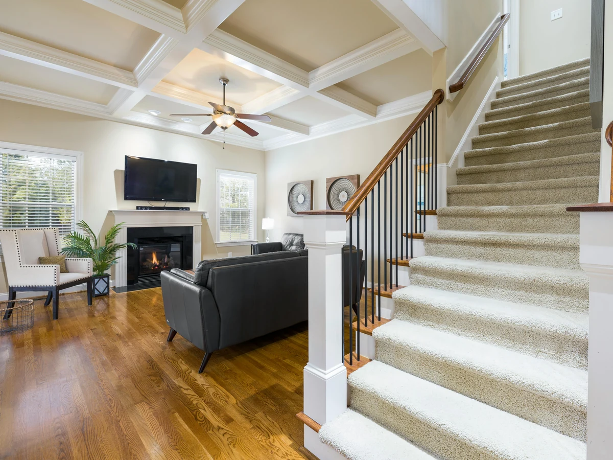 Carpeted staircase with white painted balusters and handrail by York Painters