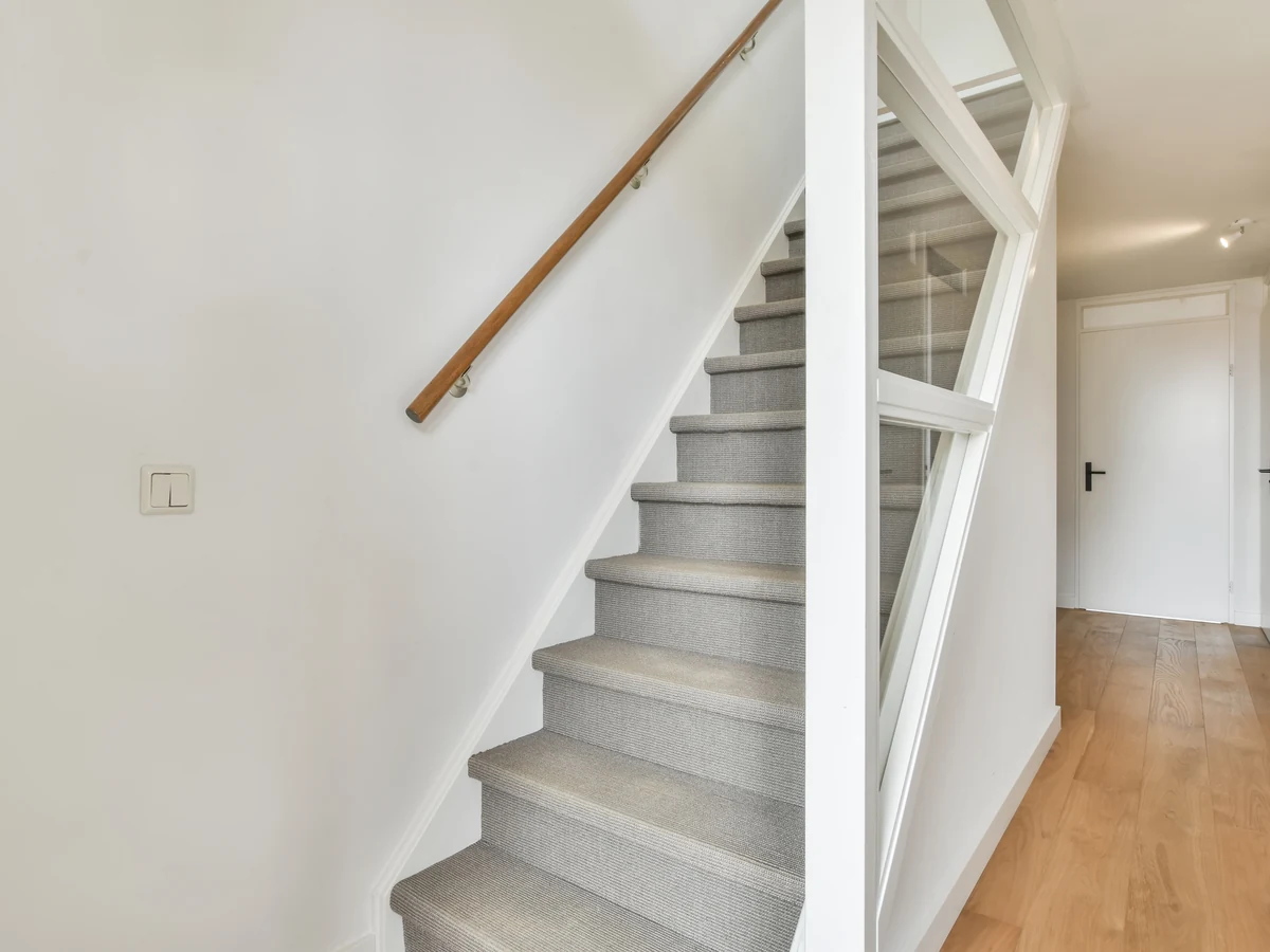 Clean white painted staircase by York Painters, professional staircase painting in York